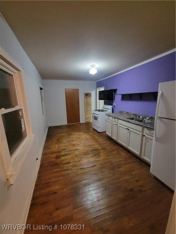 kitchen with white cabinetry, dark hardwood / wood-style flooring, white appliances, and sink