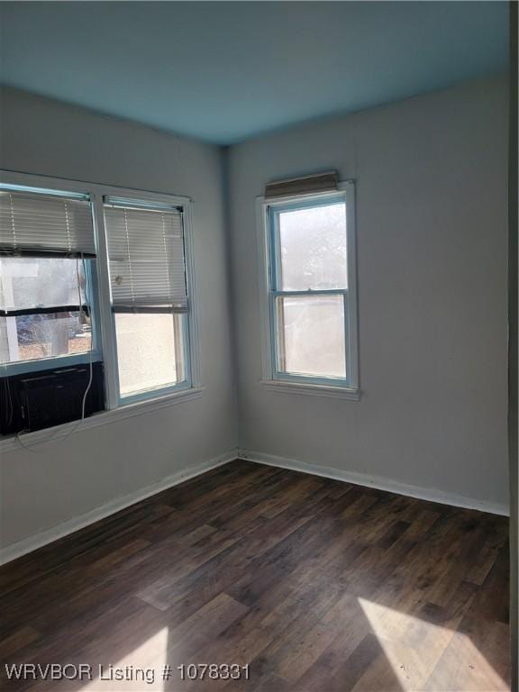 unfurnished room featuring dark wood-type flooring