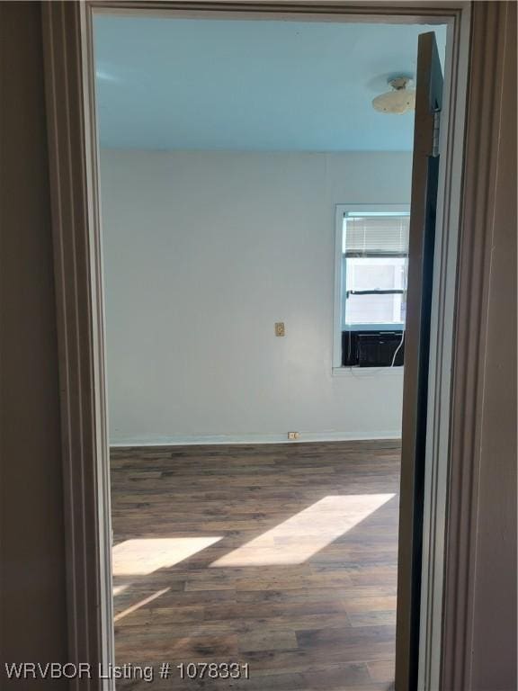 unfurnished room with wood-type flooring