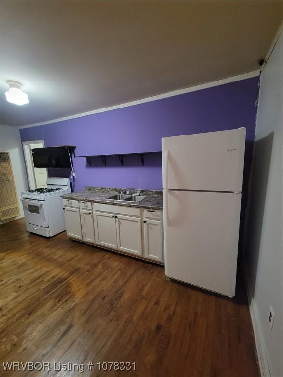 kitchen with white appliances, white cabinetry, ornamental molding, and sink