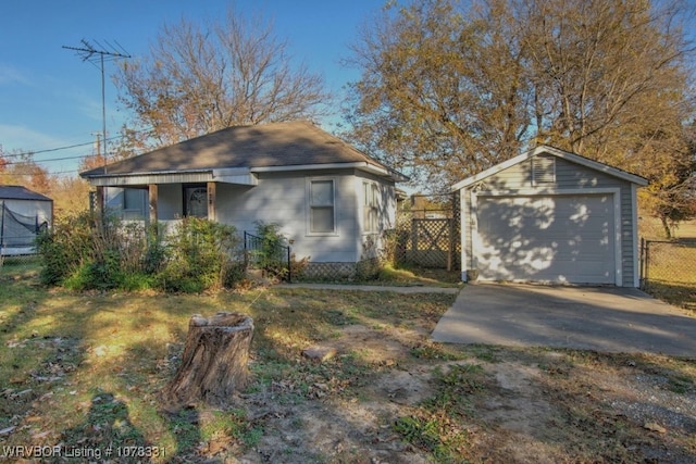 view of front of home featuring a garage and an outdoor structure