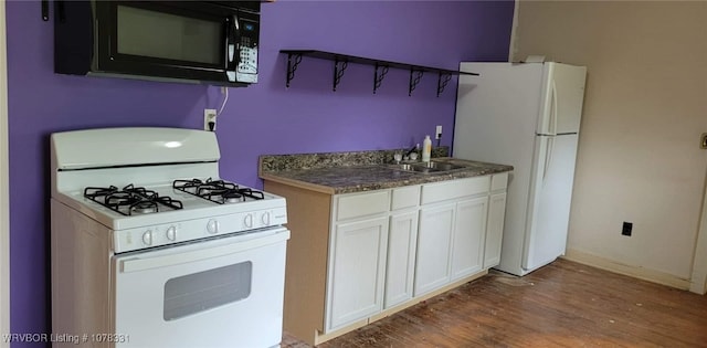 kitchen featuring dark hardwood / wood-style flooring, white appliances, white cabinetry, and sink