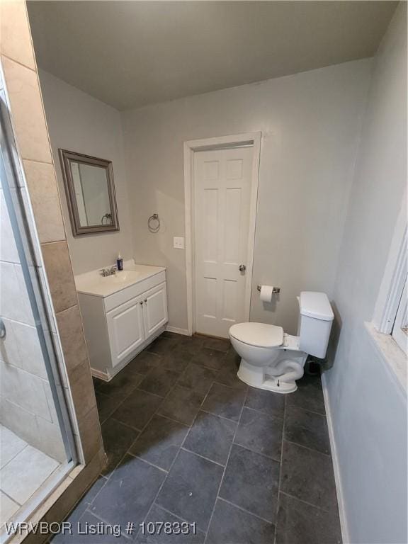 bathroom with vanity, toilet, and an enclosed shower