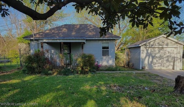 exterior space with a yard, an outbuilding, and a garage