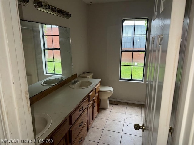 2206 Cordova Ter, Greenwood, AR 72936 - bathroom featuring toilet, double vanity, and tile patterned flooring