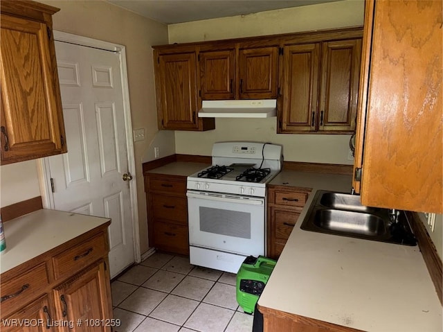 2206 Cordova Ter, Greenwood, AR 72936 - kitchen featuring under cabinet range hood, white range with gas stovetop, a sink, light tile patterned floors, and light countertops