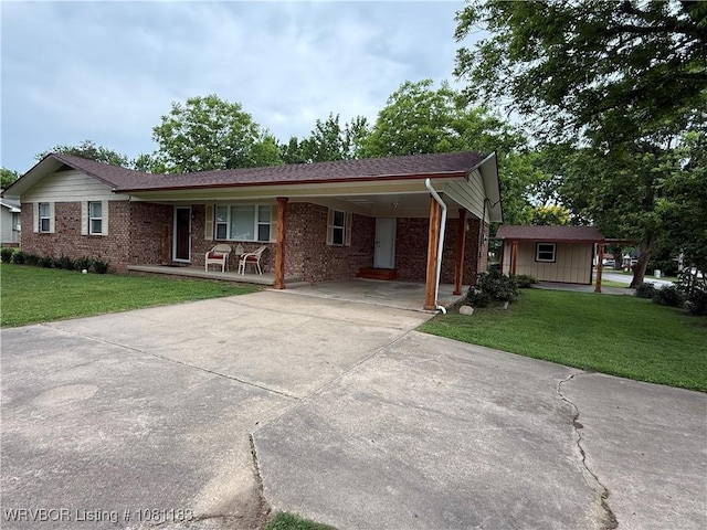 1304 S Elm St, Paris, AR 72855 - single story home featuring brick siding, concrete driveway, a front lawn, and a porch