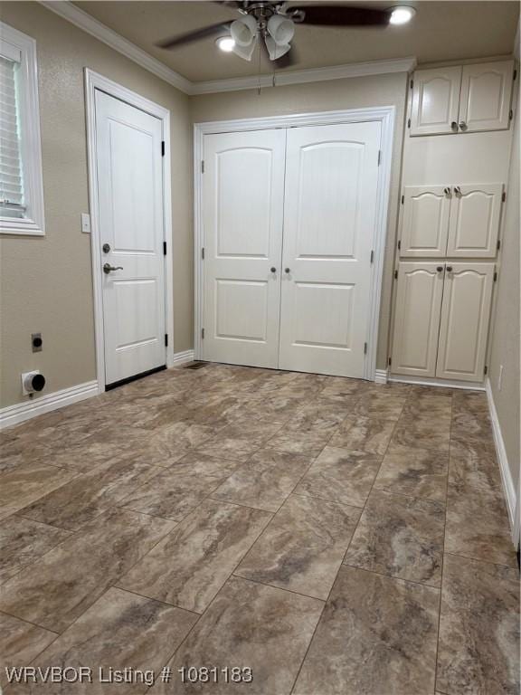 1304 S Elm St, Paris, AR 72855 - entryway with a ceiling fan, ornamental molding, and baseboards