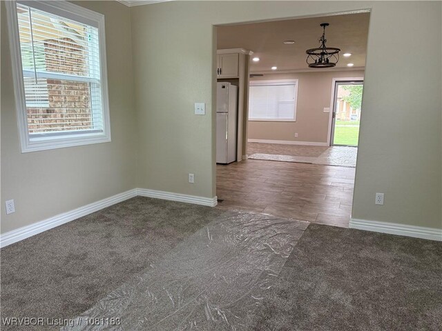 1304 S Elm St, Paris, AR 72855 - carpeted empty room featuring baseboards, a chandelier, and recessed lighting