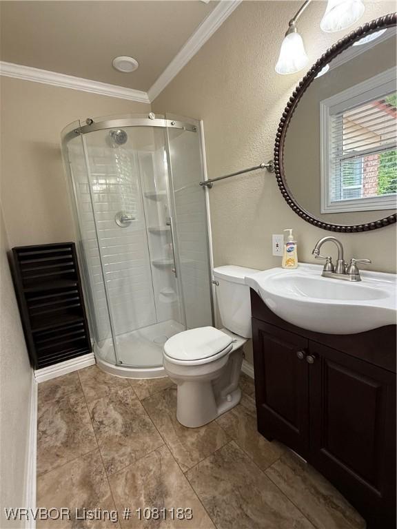 1304 S Elm St, Paris, AR 72855 - bathroom with vanity, ornamental molding, a stall shower, toilet, and a textured wall
