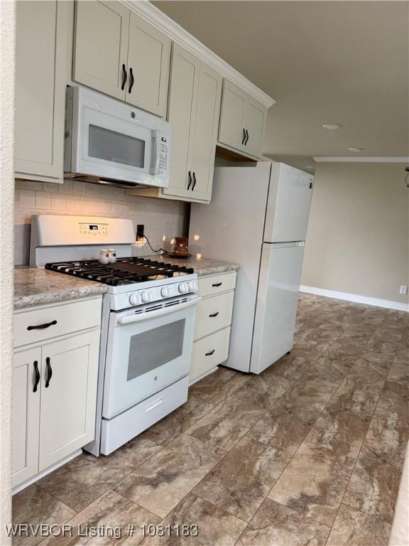 1304 S Elm St, Paris, AR 72855 - kitchen featuring white appliances, tasteful backsplash, baseboards, and light stone counters
