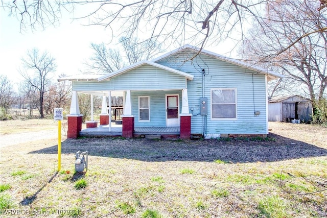 bungalow-style house with a porch and a front yard