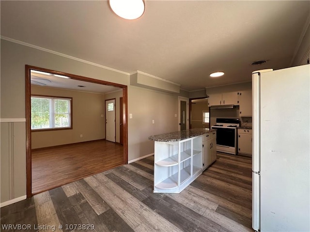 kitchen featuring dark stone countertops, dark hardwood / wood-style flooring, white appliances, and ornamental molding