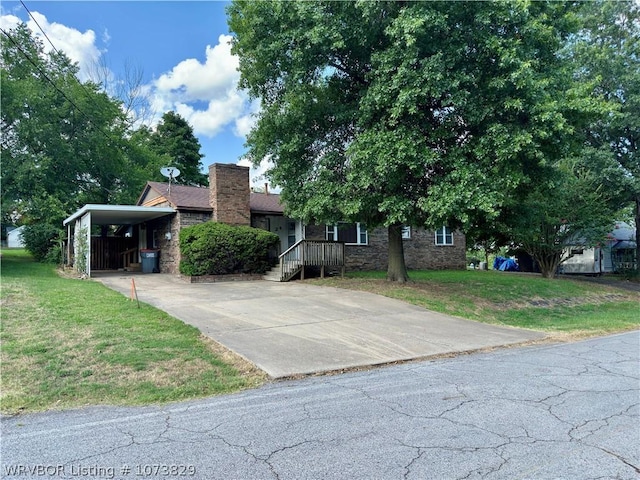 view of front facade with a front yard and a carport