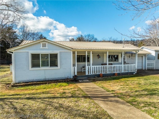 view of front facade with a garage, covered porch, and a front yard