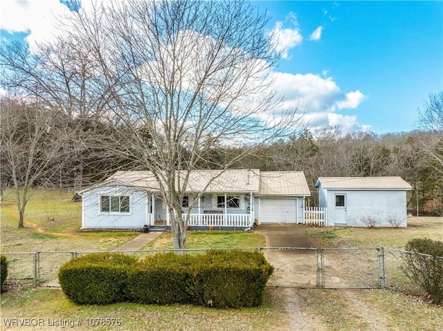 single story home with a garage, covered porch, and a front lawn