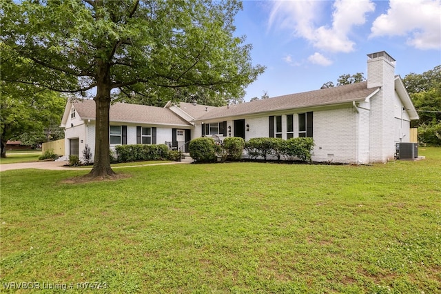 1910 S 46th St, Fort Smith, AR 72903 - single story home featuring brick siding, cooling unit, a front yard, a chimney, and an attached garage