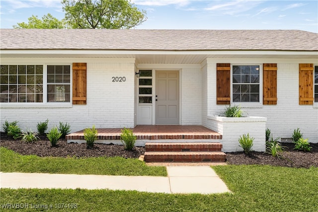 view of exterior entry with covered porch