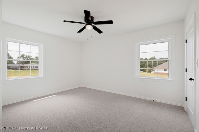 carpeted spare room with ceiling fan and a healthy amount of sunlight