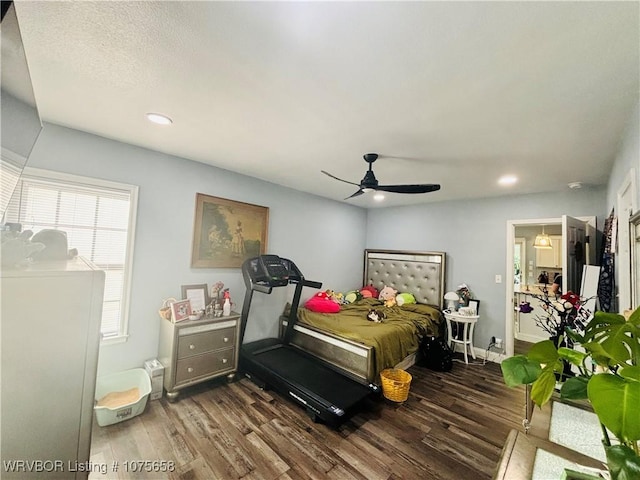 bedroom with ceiling fan and dark hardwood / wood-style flooring