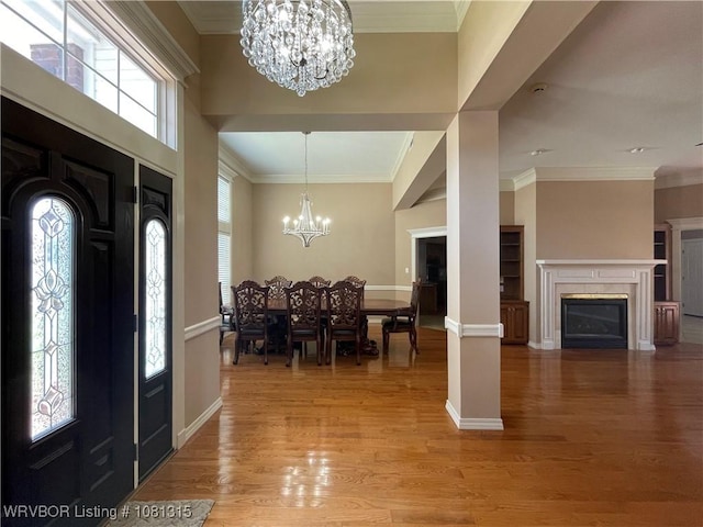 1801 Fianna Way, Fort Smith, AR 72908 - entryway with a chandelier, plenty of natural light, light wood-style floors, crown molding, and a fireplace