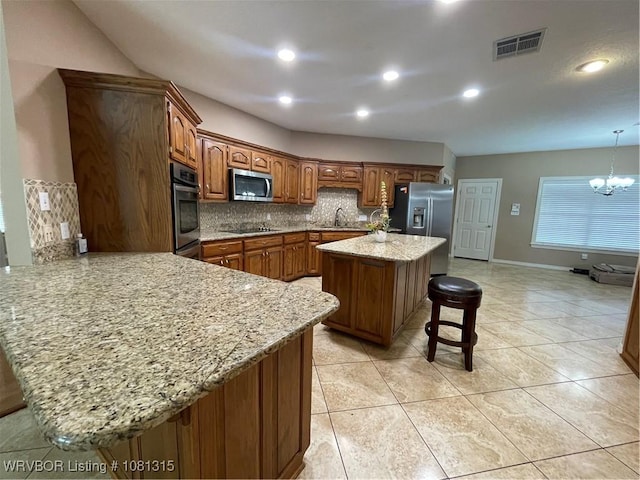 1801 Fianna Way, Fort Smith, AR 72908 - kitchen featuring appliances with stainless steel finishes, a kitchen breakfast bar, backsplash, a sink, and a peninsula