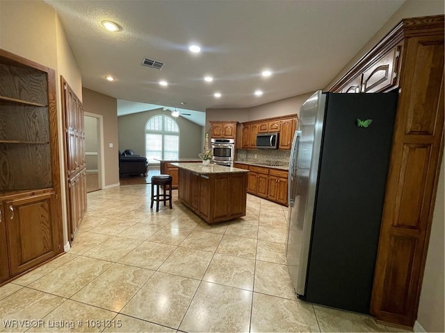 1801 Fianna Way, Fort Smith, AR 72908 - kitchen featuring appliances with stainless steel finishes, a center island with sink, a ceiling fan, backsplash, and light tile patterned floors