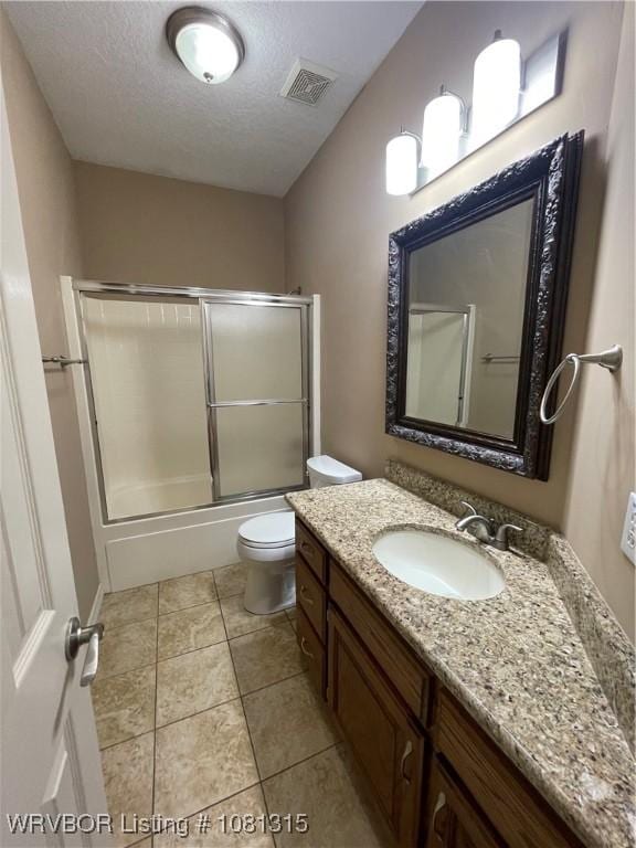 1801 Fianna Way, Fort Smith, AR 72908 - full bath featuring toilet, vanity, a textured ceiling, shower / bath combination with glass door, and tile patterned floors