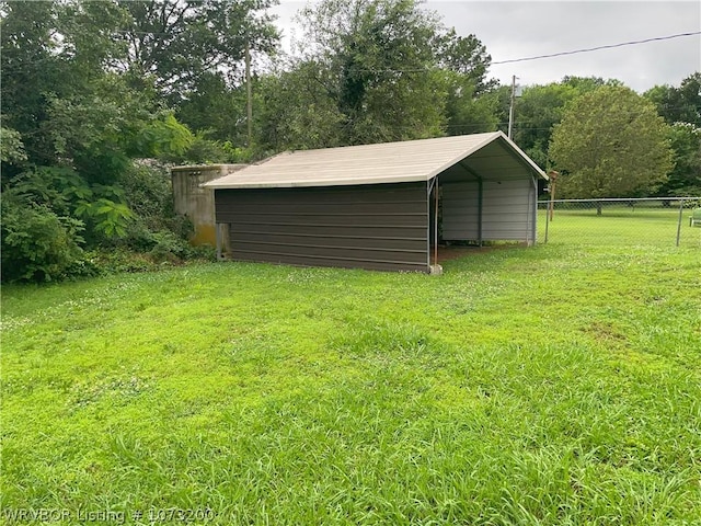 view of outbuilding featuring a yard and a carport