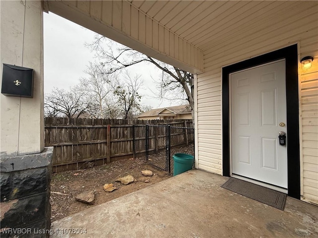 view of exterior entry with a patio