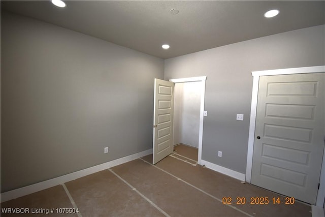 unfurnished bedroom featuring recessed lighting and baseboards