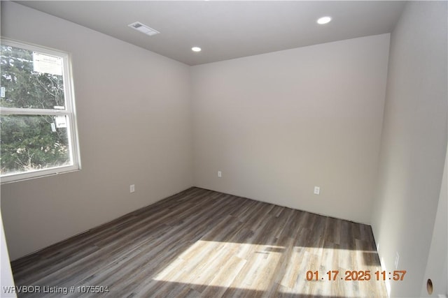 spare room featuring visible vents, dark wood finished floors, and recessed lighting