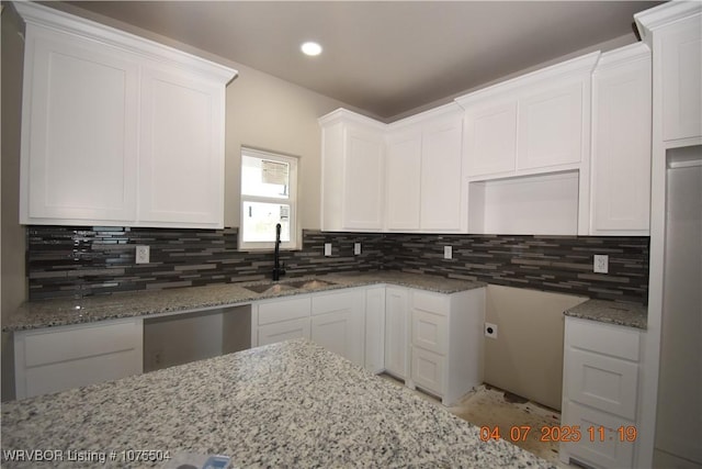 full bath with a tile shower, a bath, double vanity, and a sink