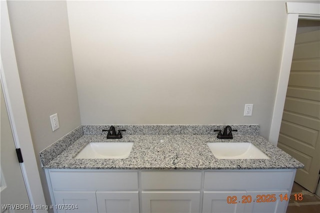 full bath with a sink and double vanity