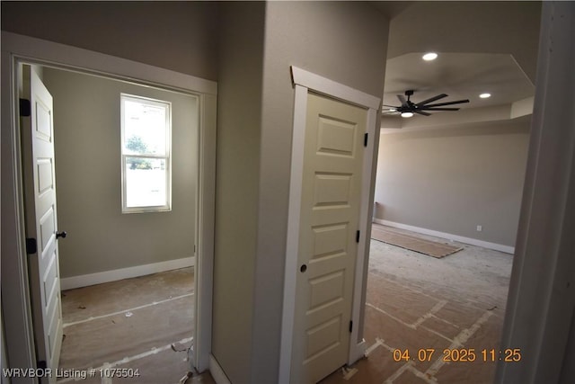 spare room featuring recessed lighting, a tray ceiling, and wood finished floors