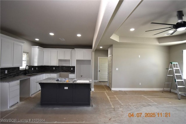 unfurnished bedroom featuring visible vents, a raised ceiling, and recessed lighting