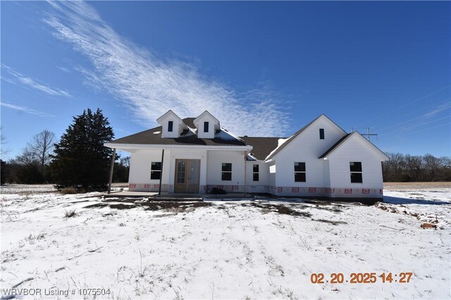 view of front of home featuring french doors and a front lawn