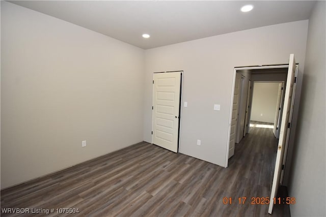 unfurnished bedroom featuring dark wood-style flooring and recessed lighting