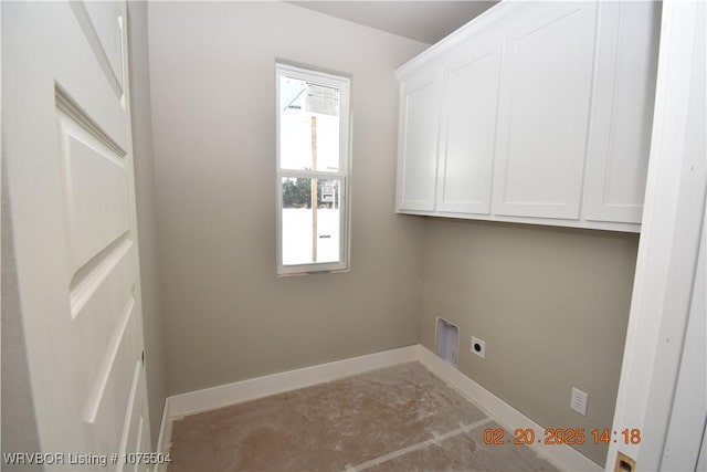 washroom featuring cabinet space, electric dryer hookup, and baseboards