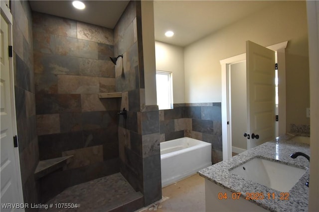 kitchen featuring recessed lighting, a center island, white cabinetry, a healthy amount of sunlight, and a sink