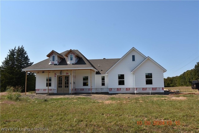 view of front of property with a front yard and french doors