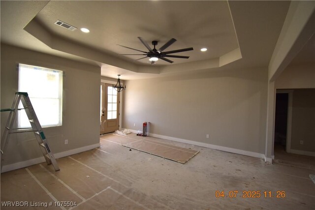 unfurnished room featuring recessed lighting, wood finished floors, and a raised ceiling