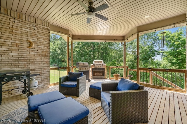 wooden terrace with a ceiling fan, a grill, and outdoor lounge area