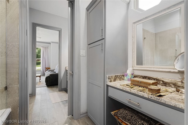 full bathroom with walk in shower and vanity