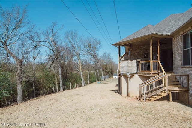 view of yard featuring stairway and covered porch