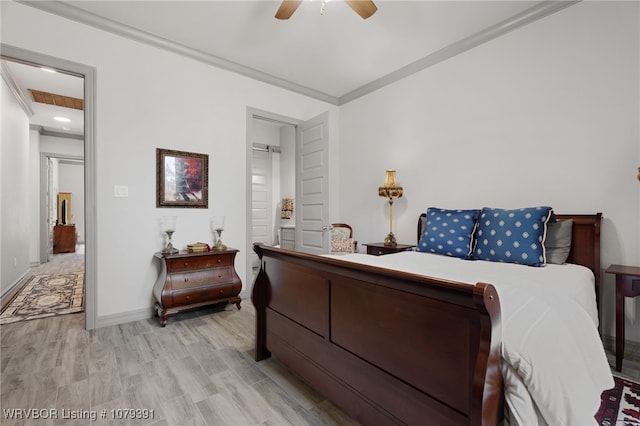 bedroom featuring visible vents, baseboards, light wood finished floors, ceiling fan, and ornamental molding