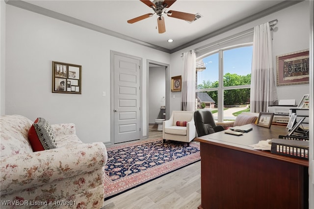 home office featuring ornamental molding, light wood finished floors, and ceiling fan