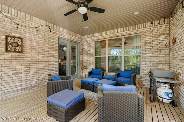 wooden deck featuring outdoor lounge area and ceiling fan