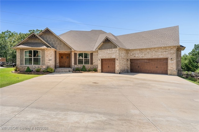 craftsman inspired home featuring driveway, brick siding, an attached garage, and a shingled roof