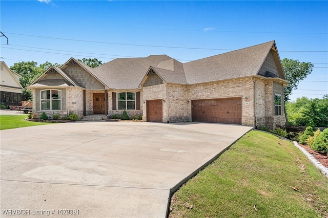 view of front of home featuring brick siding, an attached garage, concrete driveway, and a front lawn